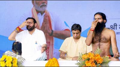 Haryana CM Nayab Singh Saini performs yoga with Ramdev during International Yoga Day celebrations, in Kurukshetra on Saturday. (PTI) Haryana CM Nayab Singh Saini performs yoga with Ramdev during International Yoga Day celebrations, in Kurukshetra on Saturday. (PTI)