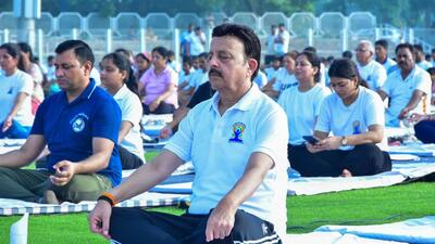 Haryana minister Rao Narbir Singh performs yoga at Tau Devi Lal Stadium in Gurugram Sector 38 on Saturday. (HT Photo)