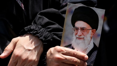 A demonstrator holds a picture of Iran's Supreme Leader Ayatollah Ali Khamenei as people gather for a rally in solidarity with Iran after Friday prayers, amid the Iran-Israel conflict, in Beirut's southern suburbs, Lebanon. (REUTERS)