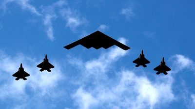 A U.S. Air Force B-2 Spirit Stealth Bomber (C) is flanked by 4 U.S. Marine Corps F-35 fighters (REUTERS)