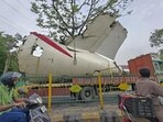 A truck carrying wreckage of the Air India plane that recently crashed into a medical hostel and its canteen complex passes by, in Ahmedabad, on Sunday. (PTI) A truck carrying wreckage of the Air India plane that recently crashed into a medical hostel and its canteen complex passes by, in Ahmedabad, on Sunday. (PTI)
