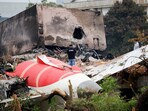 A fire officer stands next to the crashed Air India Boeing 787-8 Dreamliner aircraft, in Ahmedabad,