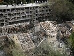 Rescue workers and firefighters survey the site of a direct missile strike launched from Iran in Tel Aviv. Rescue workers and firefighters survey the site of a direct missile strike launched from Iran in Tel Aviv.