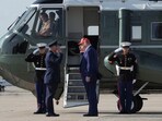 US President Donald Trump salutes Col Paul R Pawluk, Vice Commander for the 89th Airlift Wing, before boarding Marine One at Joint Base Andrews, Maryland, June 21