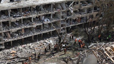 Emergency personnel work at an impact site following a missile attack from Iran on Israel in Tel Aviv. (Source: Reuters) (REUTERS)