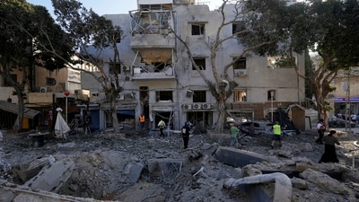 Firemen and rescue workers survey the site where a missile launched from Iran struck in Haifa, Israel, on Sunday, June 22, 2025. (AP Photo/Baz Ratner) Firemen and rescue workers survey the site where a missile launched from Iran struck in Haifa, Israel, on Sunday, June 22, 2025. (AP Photo/Baz Ratner)