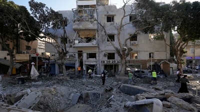 Firemen and rescue workers survey the site where a missile launched from Iran struck in Haifa, Israel, on Sunday, June 22, 2025. (AP) Firemen and rescue workers survey the site where a missile launched from Iran struck in Haifa, Israel, on Sunday, June 22, 2025. (AP)