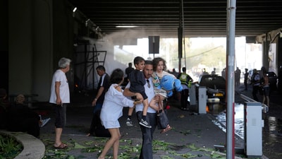 People evacuate after a missile launched from Iran struck in Haifa, Israel, Friday, June 20, 2025. (AP Photo/Baz Ratner) People evacuate after a missile launched from Iran struck in Haifa, Israel, Friday, June 20, 2025. (AP Photo/Baz Ratner)