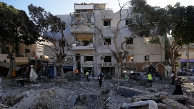 Firemen and rescue workers survey the site where a missile launched from Iran struck in Haifa, Israel, on Sunday, June 22, 2025. (AP) Firemen and rescue workers survey the site where a missile launched from Iran struck in Haifa, Israel, on Sunday, June 22, 2025. (AP)