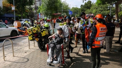 Israeli first responders evacuate an injured woman following an Iranian strike on a residential building in the Ramat Aviv area in Tel Aviv on June 22, 2025. At least 16 people were hurt and at least one impact was reported in central Israel after Iran launched two waves of missiles at the country following the US bombing of its nuclear sites, rescue services and reports said. (AFP) Israeli first responders evacuate an injured woman following an Iranian strike on a residential building in the Ramat Aviv area in Tel Aviv on June 22, 2025. At least 16 people were hurt and at least one impact was reported in central Israel after Iran launched two waves of missiles at the country following the US bombing of its nuclear sites, rescue services and reports said. (AFP)