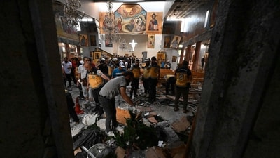 People and rescuers inspect the damage at the site of a reported suicide attack at the Saint Elias church in Damascus' Dwelaa area on June 22, 2025. (AFP) People and rescuers inspect the damage at the site of a reported suicide attack at the Saint Elias church in Damascus' Dwelaa area on June 22, 2025. (AFP)