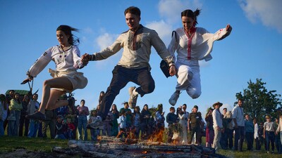 People jump over bonfire during a traditional midsummer celebration in Pyrohiv, Ukraine, outside of Kyiv, Saturday, June 21, 2025. (AP Photo/Efrem Lukatsky) (AP) People jump over bonfire during a traditional midsummer celebration in Pyrohiv, Ukraine, outside of Kyiv, Saturday, June 21, 2025. (AP Photo/Efrem Lukatsky) (AP)