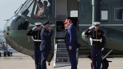 US President Donald Trump salutes Col Paul R Pawluk, Vice Commander for the 89th Airlift Wing, before boarding Marine One at Joint Base Andrews, Maryland, June 21 (REUTERS)