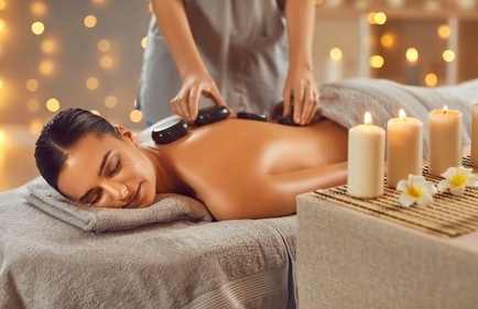 Warm stones are strategically placed in hot stone therapy. (Shutterstock)