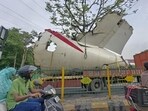 A truck carrying wreckage of the Air India plane that recently crashed into a medical hostel and its canteen complex passes by, in Ahmedabad. A truck carrying wreckage of the Air India plane that recently crashed into a medical hostel and its canteen complex passes by, in Ahmedabad.