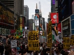 Protesters hold signs during a protest against U.S. strikes on Iran, Sunday, June 22, 2025, in New York. AP/PTI(AP06_23_2025_000007B)