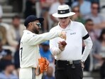 Rishabh Pant (L) complains about the shape of the ball to Australia's umpire Paul Reiffel (R) on day 3 of the first cricket test match between England and India 