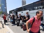 Israelis disembark a bus after they were flown back to Israel in a special flight, on June 16, 2025, in Tel Aviv.