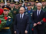 Russia's President Vladimir Putin (C) and Russian defence minister Andrei Belousov.