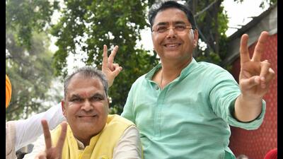 AAP candidate Sanjeev Arora along with party president Aman Arora during a victory march in Ludhiana on Monday. (Gurpreet Singh/HT) AAP candidate Sanjeev Arora along with party president Aman Arora during a victory march in Ludhiana on Monday. (Gurpreet Singh/HT)