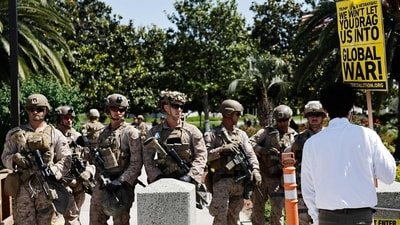 A demonstrator protests near US Marines guarding the Wilshire Federal Building during a rally opposing the US strikes in Iran. (Source: AFP) (Getty Images via AFP) A demonstrator protests near US Marines guarding the Wilshire Federal Building during a rally opposing the US strikes in Iran. (Source: AFP) (Getty Images via AFP)