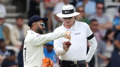 Rishabh Pant (L) complains about the shape of the ball to Australia's umpire Paul Reiffel (R) on day 3 of the first cricket test match between England and India (AFP)