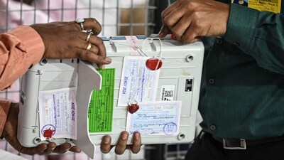Election Commission of India (ECI) staff break the seal of an Electronic Voting Machine (EVM) in Mumbai. (For representation/AFP) Election Commission of India (ECI) staff break the seal of an Electronic Voting Machine (EVM) in Mumbai. (For representation/AFP)