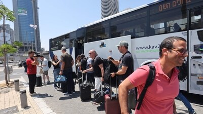 Israelis disembark a bus after they were flown back to Israel in a special flight, on June 16, 2025, in Tel Aviv. (AFP) Israelis disembark a bus after they were flown back to Israel in a special flight, on June 16, 2025, in Tel Aviv. (AFP)