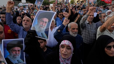 Protesters chant slogans as they hold up posters of the Iranian Supreme Leader Ayatollah Ali Khamenei in a protest following the US attacks. (AP) Protesters chant slogans as they hold up posters of the Iranian Supreme Leader Ayatollah Ali Khamenei in a protest following the US attacks. (AP)