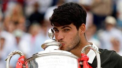 Spain's Carlos Alcaraz celebrates with the Queen’s Club Championship trophy after winning his final against Czech Republic's Jiri Lehecka (Reuters) Spain's Carlos Alcaraz celebrates with the Queen’s Club Championship trophy after winning his final against Czech Republic's Jiri Lehecka (Reuters)