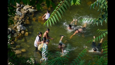 Youngsters play in a stream during a hot day on the outskirts of Srinagar, on Monday. (PTI) Youngsters play in a stream during a hot day on the outskirts of Srinagar, on Monday. (PTI)