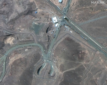 This handout satellite picture taken on June 19 shows trucks positioned near the entrance of Iran's Fordow Fuel Enrichment Plant. (Source: AFP) (AFP)