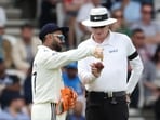Rishabh Pant (L) complains about the shape of the ball to Australia's umpire Paul Reiffel (R) on day 3 of the first cricket test match between England and India 