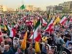 Protestors carry Iranian national flags and posters of the late revolutionary founder Ayatollah Khomeini and Supreme Leader Ayatollah Ali Khamenei, while chanting anti U.S. and Israel slogans, in Tehran, Iran, Tuesday, June 24, 2025. Protestors carry Iranian national flags and posters of the late revolutionary founder Ayatollah Khomeini and Supreme Leader Ayatollah Ali Khamenei, while chanting anti U.S. and Israel slogans, in Tehran, Iran, Tuesday, June 24, 2025.