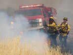 Firefighters operate during a brushfire. 