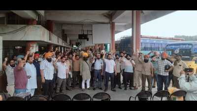 Contractual workers of Punjab Roadways, Punbus and PRTC during a protest at the Ludhiana bus stand on Tuesday. (HT Photo)