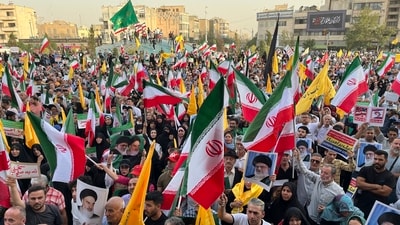 Protestors carry Iranian national flags and posters of the late revolutionary founder Ayatollah Khomeini and Supreme Leader Ayatollah Ali Khamenei, while chanting anti U.S. and Israel slogans, in Tehran, Iran, Tuesday, June 24, 2025. (AP) Protestors carry Iranian national flags and posters of the late revolutionary founder Ayatollah Khomeini and Supreme Leader Ayatollah Ali Khamenei, while chanting anti U.S. and Israel slogans, in Tehran, Iran, Tuesday, June 24, 2025. (AP)