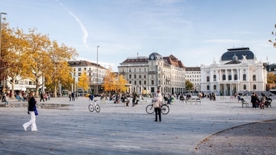 Locals soak in the sun and fall colors at Zurich’s vibrant central square.