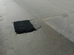 BBMP used tar to cover the damaged portions of a concrete road, a move that engineers and commuters alike say is both ineffective and short-lived. 