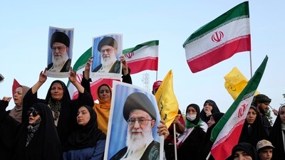 Iranian protesters hold their country's flags and posters of Supreme Leader Ayatollah Ali Khamenei in an anti-U.S. and anti-Israeli rally at Enqelab-e-Eslami (Islamic Revolution) square in downtown Tehran, Iran, Tuesday, June 24, 2025. (AP) Iranian protesters hold their country's flags and posters of Supreme Leader Ayatollah Ali Khamenei in an anti-U.S. and anti-Israeli rally at Enqelab-e-Eslami (Islamic Revolution) square in downtown Tehran, Iran, Tuesday, June 24, 2025. (AP)