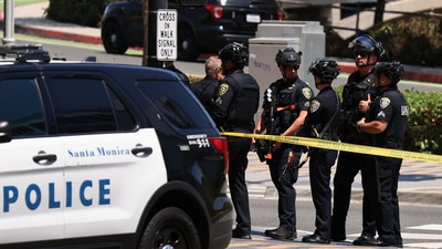 Police in tactical gear gather during a search for a suspect, after a police officer was shot near the Santa Monica Place mall. (REUTERS)