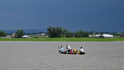 People wade through flood waters on a boat at Lehpati village of Morigaon district in India's northeastern state of Assam on July 3, 2024. (Photo by Biju BORO / AFP) (AFP) People wade through flood waters on a boat at Lehpati village of Morigaon district in India's northeastern state of Assam on July 3, 2024. (Photo by Biju BORO / AFP) (AFP)
