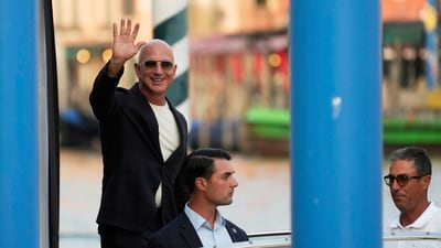 Amazon multi-billionaire founder Jeff Bezos waves as he leaves by boat an hotel in Venice, Italy, on Wednesday, June 25, 2025, ahead of festivities in the lagoon city reportedly linked to his wedding with Lauren Sanchez. (AP Photo/Luca Bruno) (AP) Amazon multi-billionaire founder Jeff Bezos waves as he leaves by boat an hotel in Venice, Italy, on Wednesday, June 25, 2025, ahead of festivities in the lagoon city reportedly linked to his wedding with Lauren Sanchez. (AP Photo/Luca Bruno) (AP)