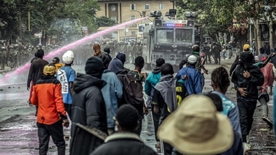 Protesters gather in front of a police cordon backed by a water cannon truck during clashes in downtown Nairobi on June 25, 2025. (AFP) Protesters gather in front of a police cordon backed by a water cannon truck during clashes in downtown Nairobi on June 25, 2025. (AFP)