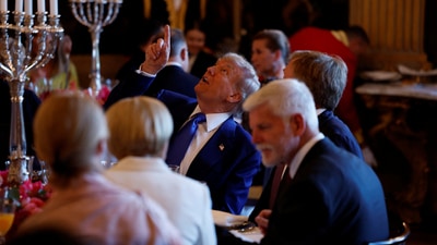 US President Donald Trump and Dutch King Willem-Alexander look up ahead of a dinner with heads of state and government at Paleis Huis Ten Bosch at the invitation of Dutch King Willem-Alexander, in The Hague, The Netherlands, 24 June 2025. Remko de Waal/Pool via REUTERS (via REUTERS)
