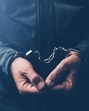 Arrested computer hacker and cyber criminal with handcuffs, close up of hands (Getty Images/iStockphoto) Arrested computer hacker and cyber criminal with handcuffs, close up of hands (Getty Images/iStockphoto)