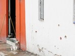 Votive candles are placed near the bullet-riddled house where gunmen opened fire on Tuesday during a party celebrating the Nativity of John the Baptist. (Source: Reuters)