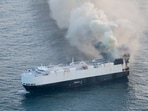 Smoke rises from a fire aboard the cargo vessel Morning Midas, carrying around 3,000 vehicles, including 800 electric vehicles