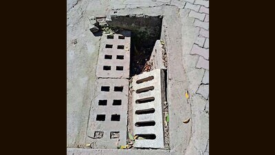 A broken road gully in Sector 5, Panchkula. (HT Photo)