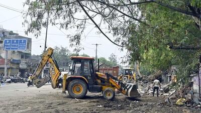 Bulldozers raze slum structures in Loni on June 18. (Sanjeev Verma/HT Photo) Bulldozers raze slum structures in Loni on June 18. (Sanjeev Verma/HT Photo)